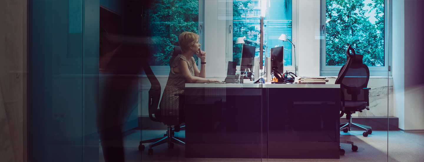 a woman sitting at a desk in an office